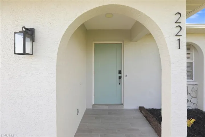 Entrance to property with stucco siding