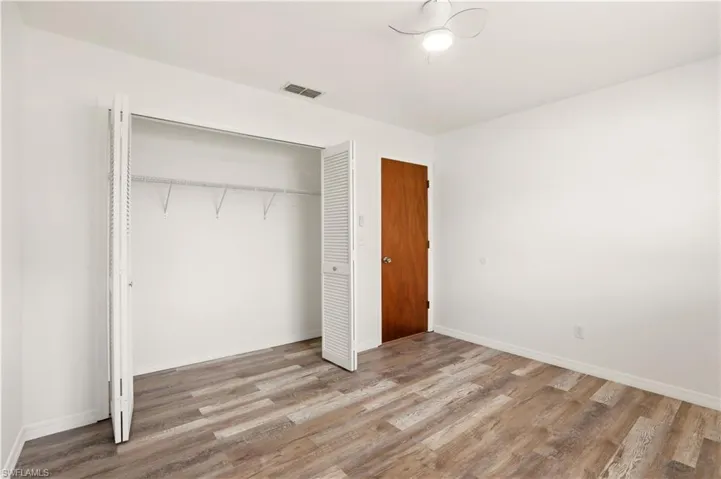 Unfurnished bedroom featuring light wood-style floors and a closet