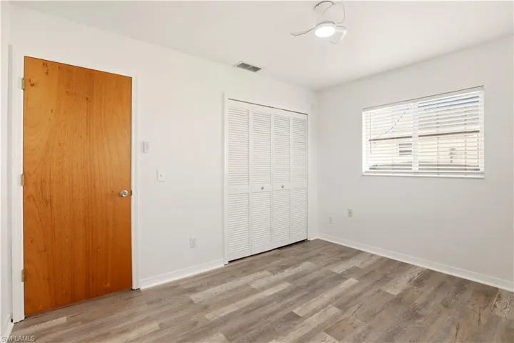Unfurnished bedroom featuring light wood finished floors and a closet