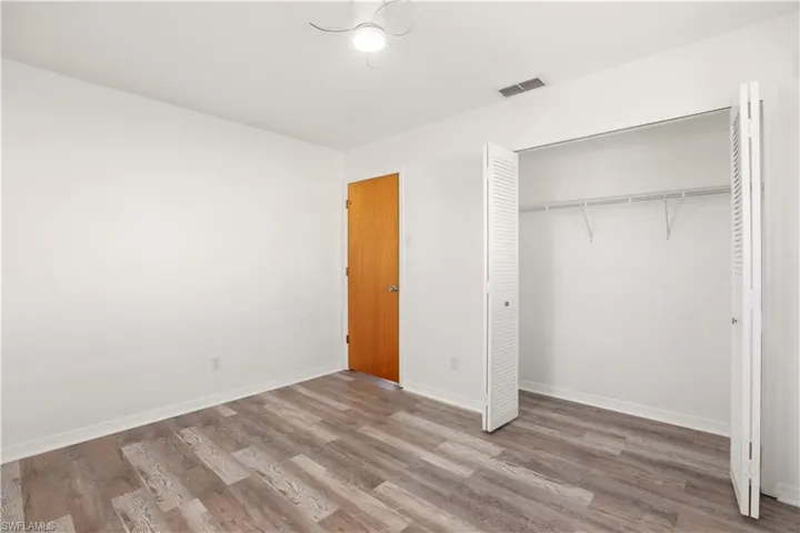 Unfurnished bedroom with light wood finished floors and a closet