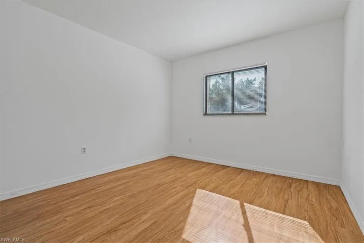 Spare room with light wood-style floors and baseboards