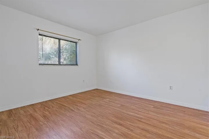 Unfurnished room with light wood-style floors and baseboards