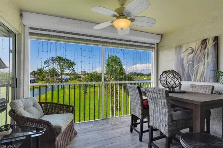 Sunroom / solarium with a wealth of natural light, a water view, and ceiling fan