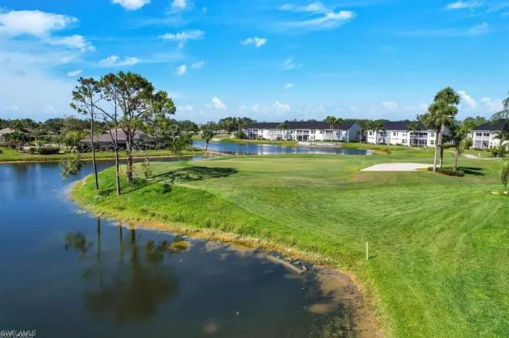 View of property's community with a water view and a lawn