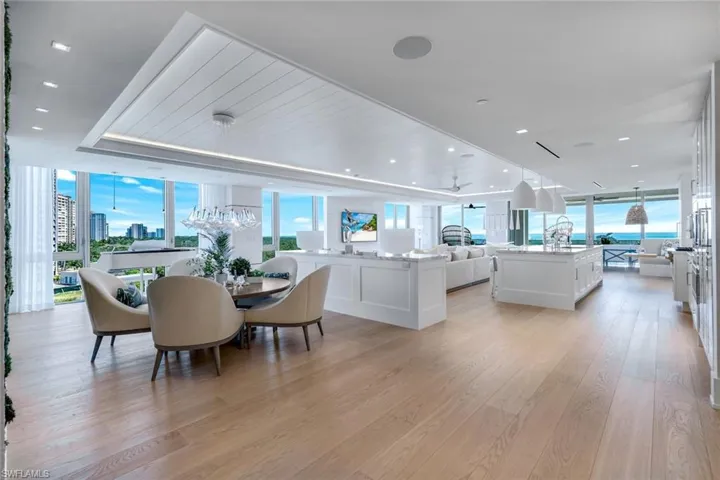 Dining room featuring expansive windows, light wood-type flooring, and recessed lighting