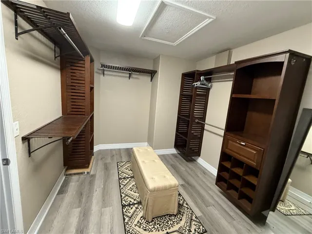 Walk in closet with hardwood shelving