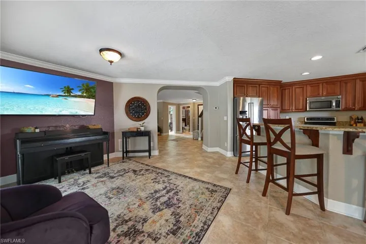 Tiled living room with a textured ceiling and crown molding