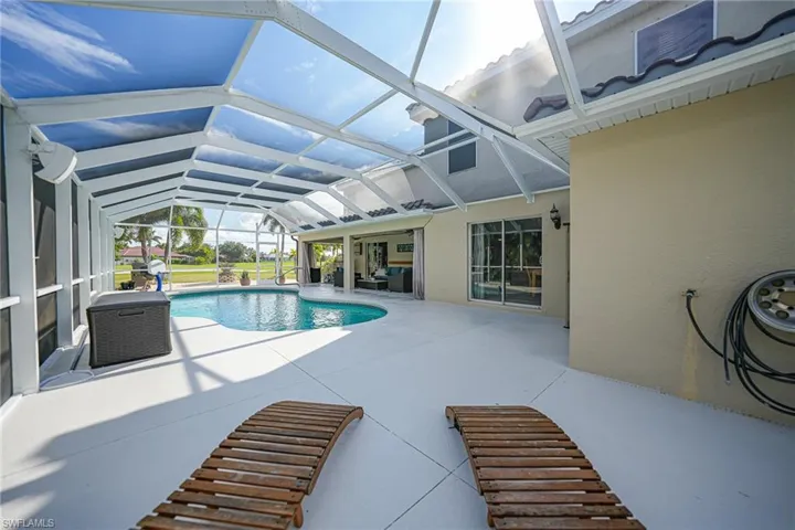 View of swimming pool with a lanai and a patio