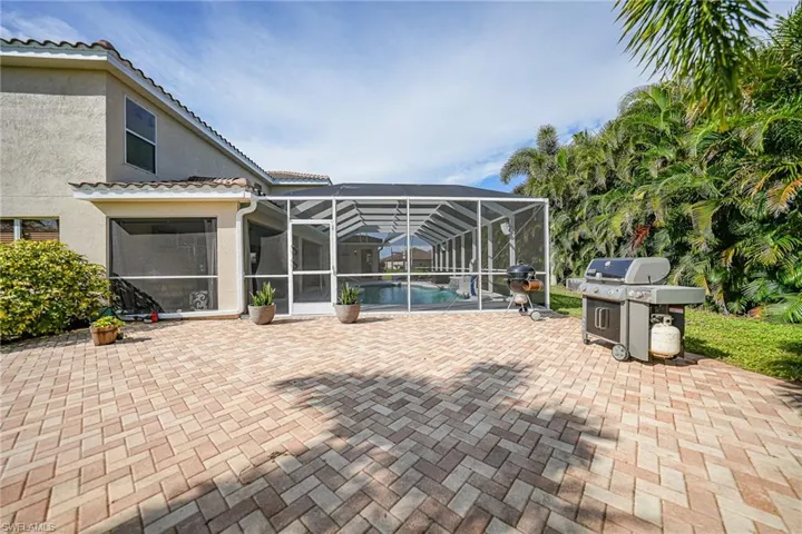 View of patio / terrace with glass enclosure and a grill
