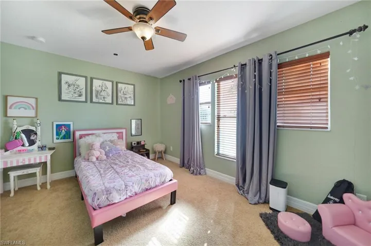 Bedroom with light carpet and ceiling fan