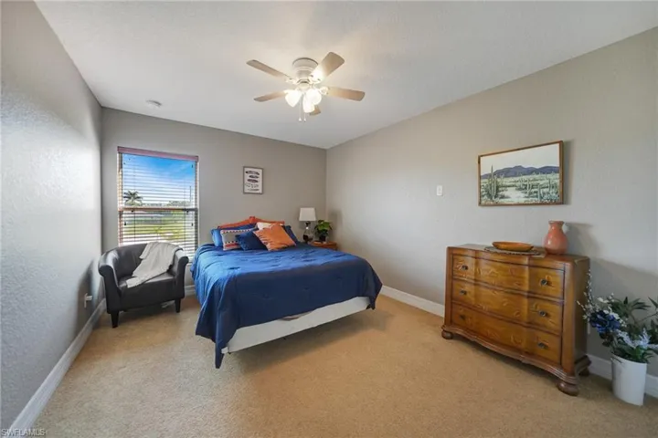 Bedroom featuring ceiling fan and light colored carpet