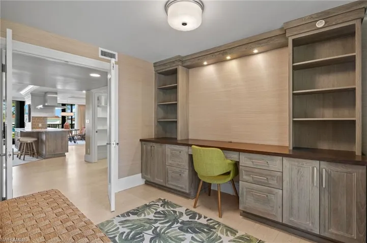 Office space featuring light hardwood / wood-style flooring and built in desk