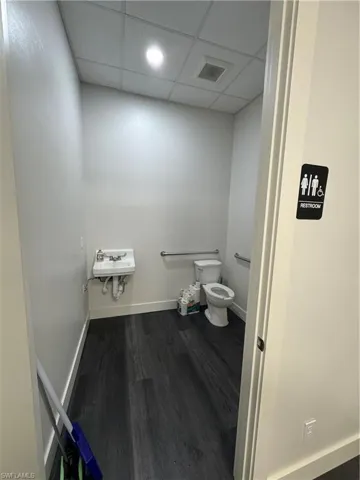 Bathroom with a drop ceiling and recessed lighting