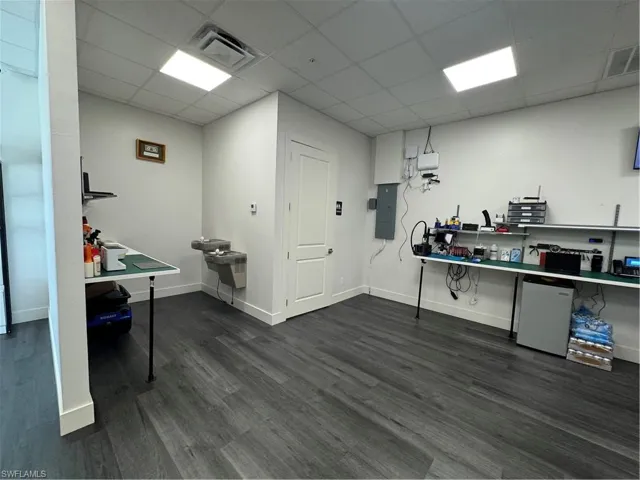 Miscellaneous room with a drop ceiling and electric panel