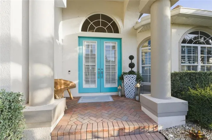 Doorway to property with french doors and stucco siding