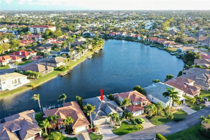 Aerial view of property's location with nearby suburban area and a nearby body of water