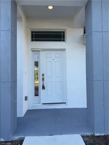 Entrance to property featuring a patio and stucco siding