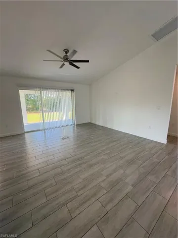 Spare room with wood tiled floors and a ceiling fan