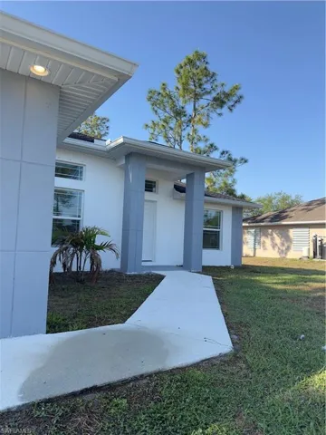 Doorway to property with a yard