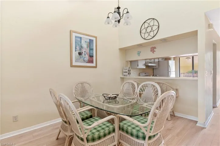 Dining area featuring light hardwood / wood-style floors and a notable chandelier