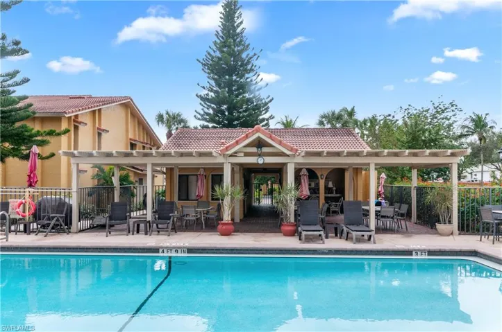 View of swimming pool with a patio area and an outdoor structure