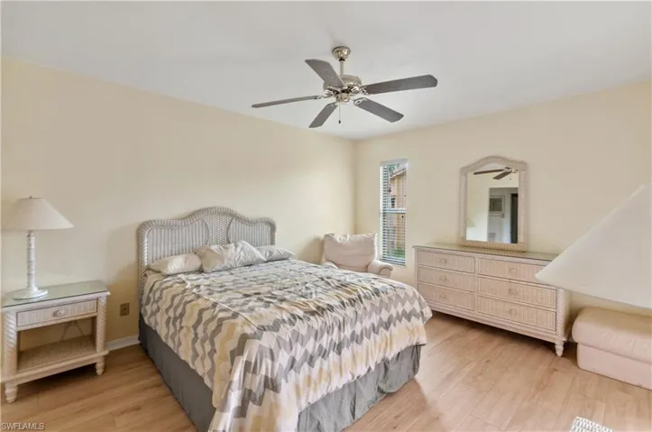 Bedroom featuring ceiling fan and light hardwood / wood-style flooring