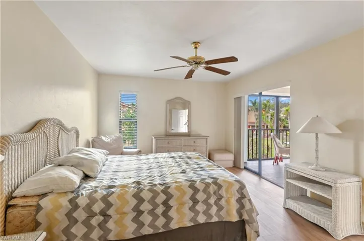 Bedroom with ceiling fan, access to exterior, and light hardwood / wood-style flooring