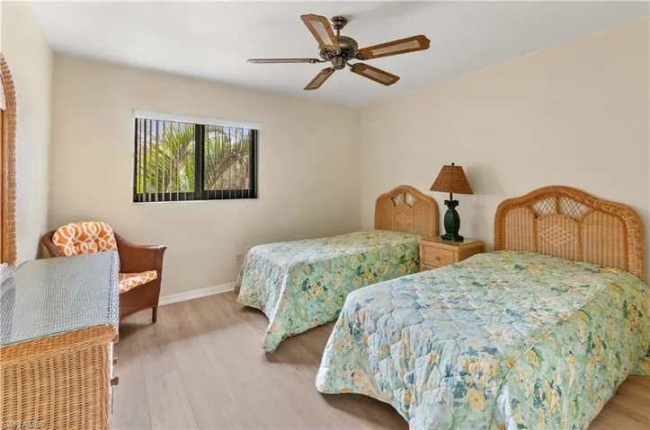 Bedroom with ceiling fan and light wood-type flooring