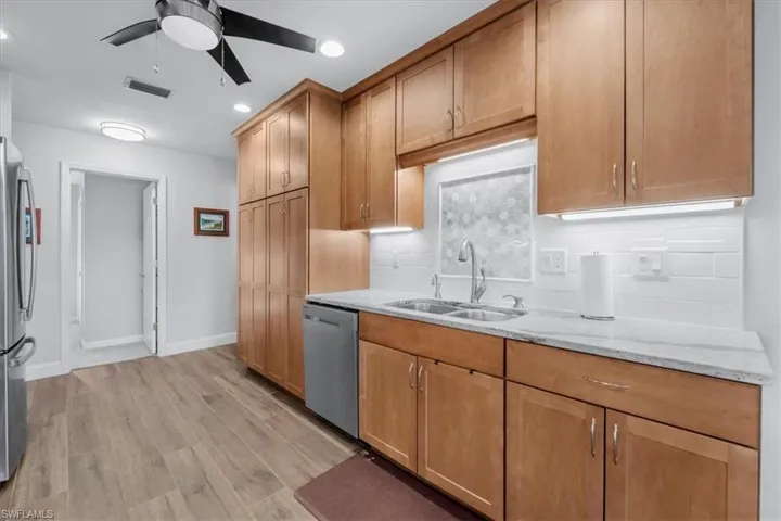 Kitchen featuring wood look tile flooring and light wood cabinetry with brushed nickel hardware