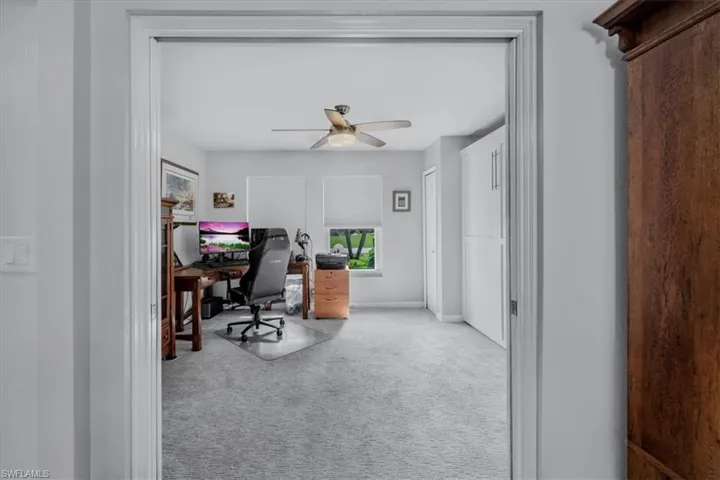 Spacious room featuring light gray carpeting and white walls