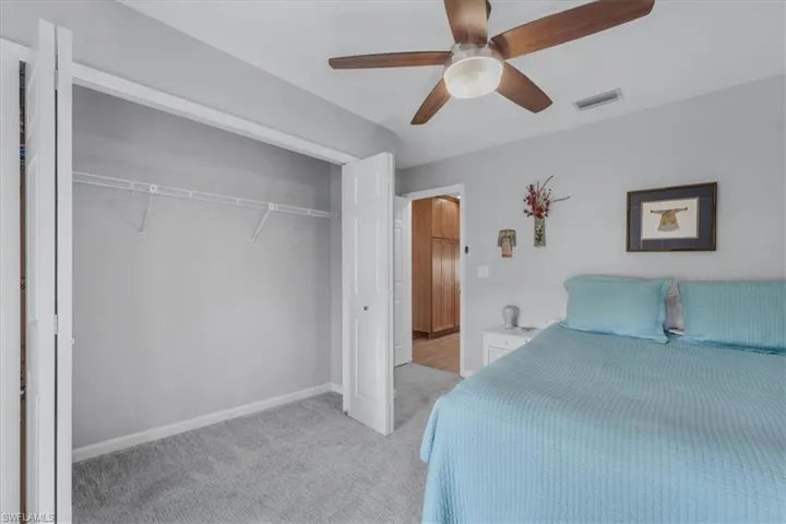 Room featuring light gray wall paint and gray carpet flooring