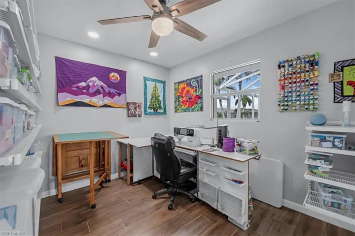 Versatile room featuring wood look Tile flooring and a ceiling fan with integrated lighting
