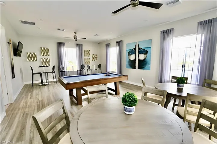 Game room with billiards table and ceiling fan