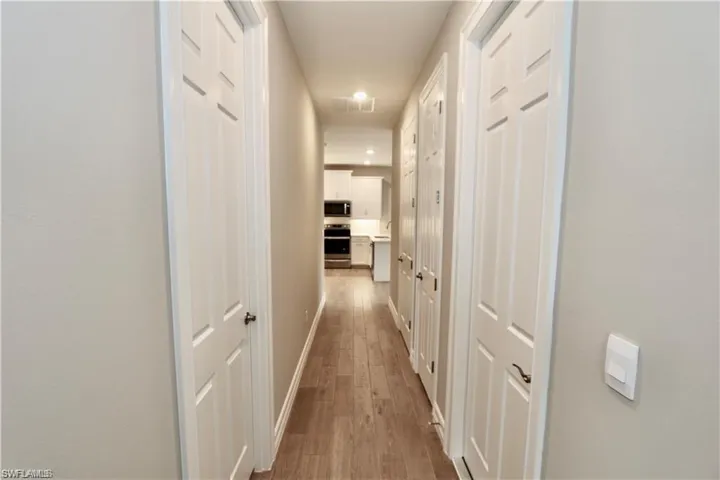 Corridor featuring wood-type flooring and baseboards