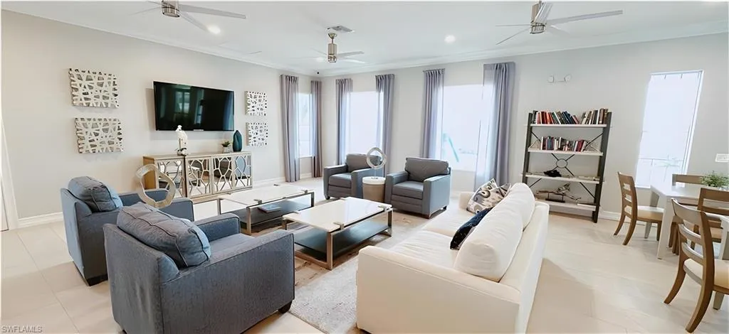 Living area featuring ornamental molding, ceiling fan, and recessed lighting