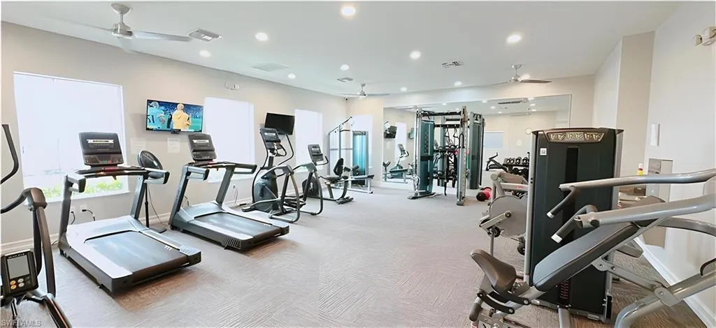 Exercise room featuring a ceiling fan and recessed lighting