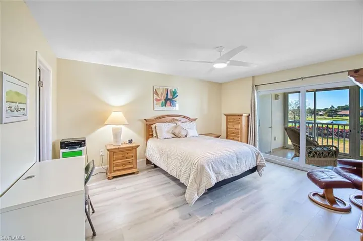 Master Bedroom with light wood-style flooring, access to outside, and a ceiling fan