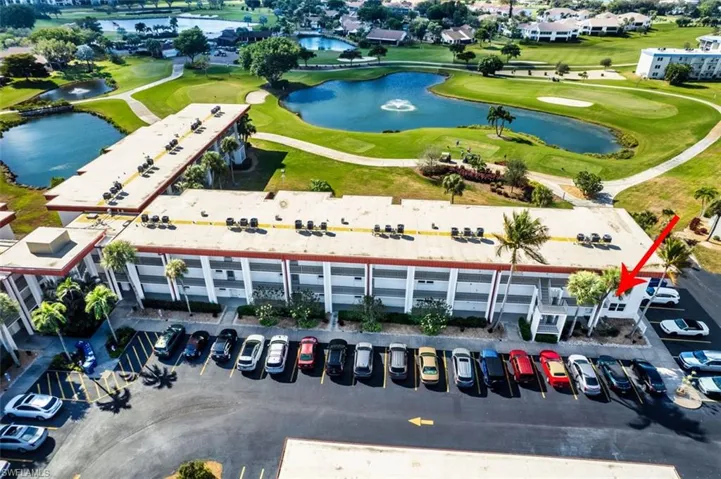Aerial overview of property's location with a golf course and a large body of water
