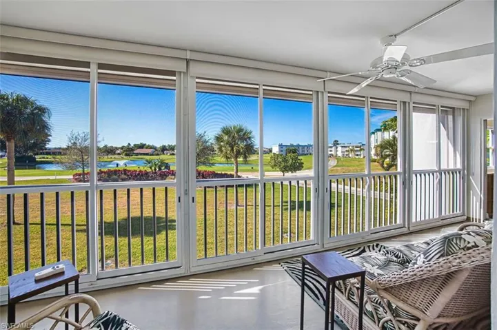 Sunroom featuring concrete flooring and a water view