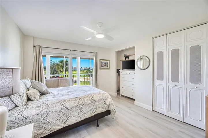Guest Bedroom with access to outside, a ceiling fan, light wood-style flooring, and a closet