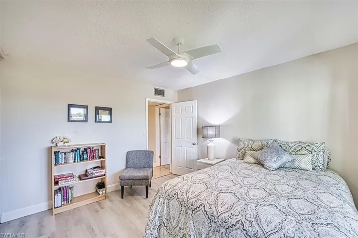 Guest Bedroom featuring a textured ceiling, ceiling fan, and light wood-style flooring