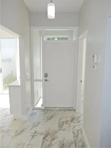 Entryway with light tile flooring