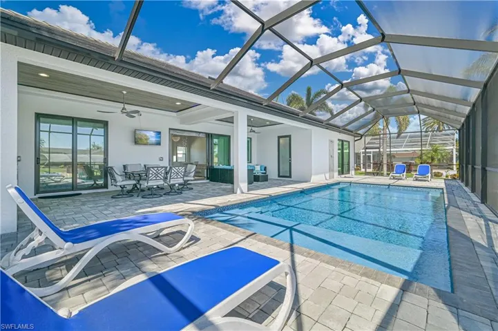 Pool featuring a lanai, a patio area, and ceiling fan