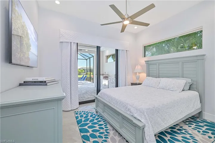 Bedroom with access to exterior, multiple windows, and recessed lighting