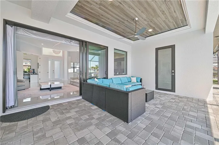 View of patio with an outdoor hangout area and a ceiling fan