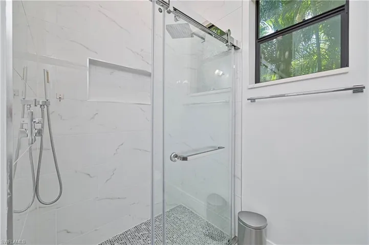 Bathroom with a marble finish shower
