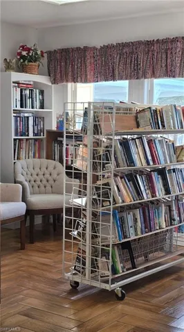 Wood-finish flooring in a herringbone pattern with built-in shelving