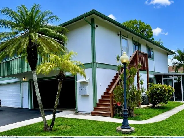 Back/Side of Condo with Pretty Lamp Post. End Unit with Attached Garage with Extra Storage. Virtually enhanced