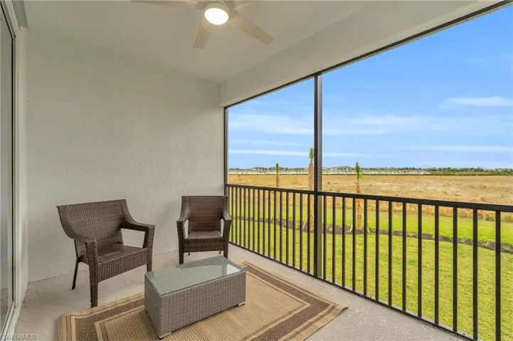 Balcony featuring ceiling fan and a rural view