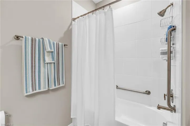 Bathroom featuring shower / bath combination with curtain